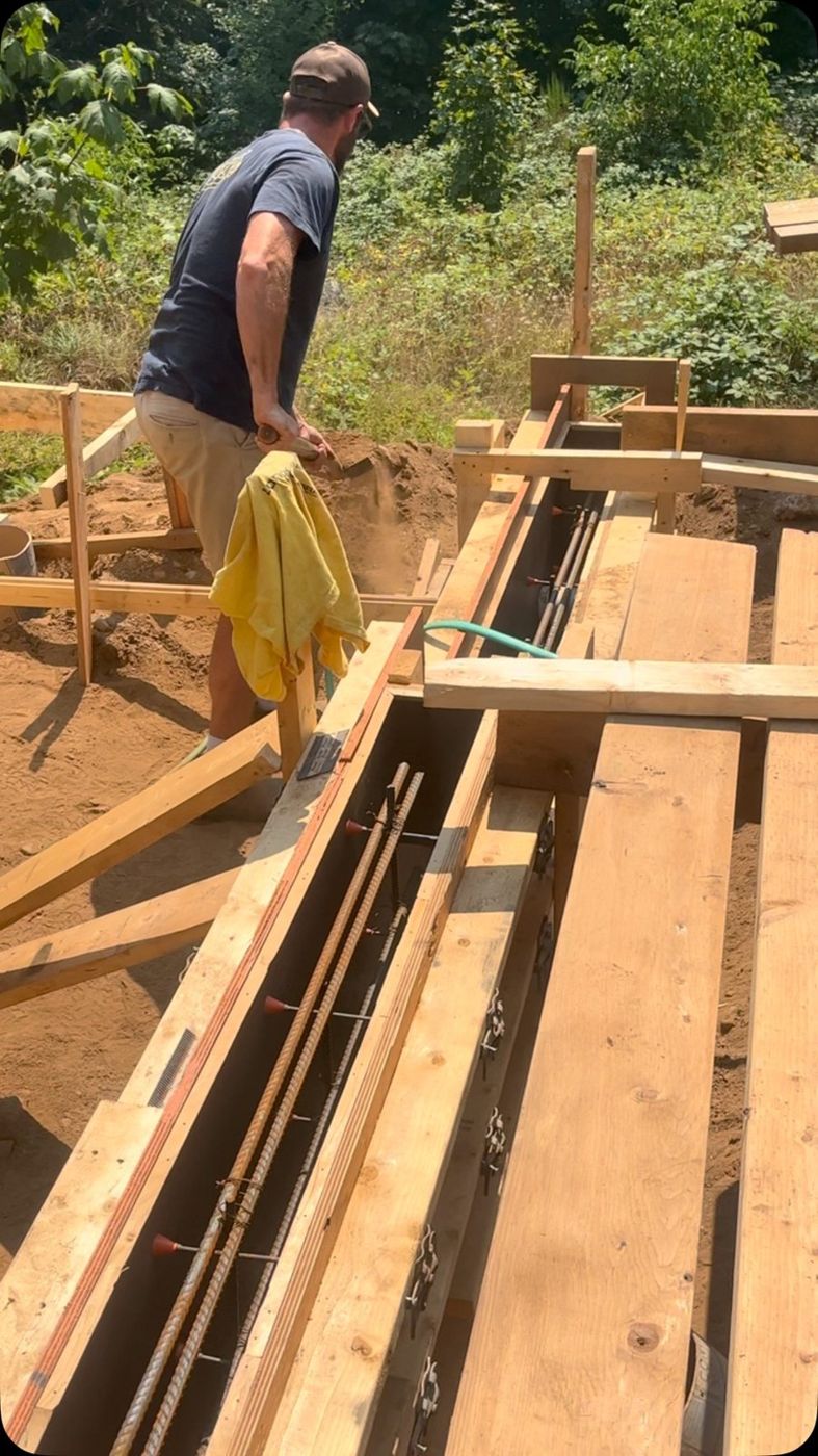 Crew setting concrete forms with rebar